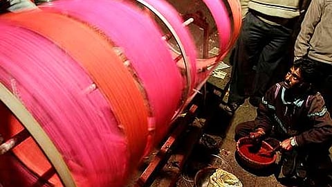 A man preparing kite strings. Image used for representational purpose