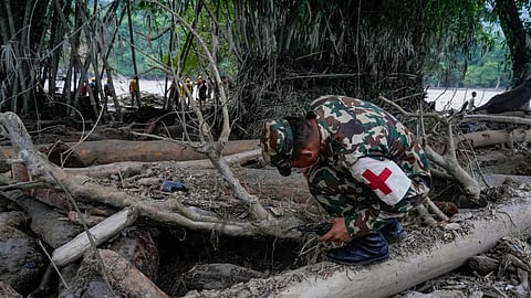 A Nepal Army official conduct a search and rescue operation along side a river area at Charaudi, in Dhading district, Nepal, Friday, Friday, Aug. 28, 2026.