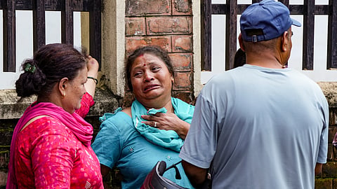 Family members and relatives mourn outside a hospital mortuary after identifying their loved ones who died in the flash floods, in Kathmandu, Nepal, Saturday, Aug. 29, 2026