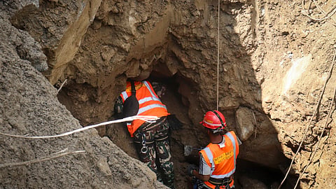 An officer of Nepal Army rescue team navigate through the dark