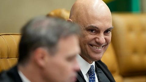 Supreme Court Justice Alexandre de Moraes smiles alongside Justice Andre Mendonca during a plenary session of the court in Brasilia, Brazil