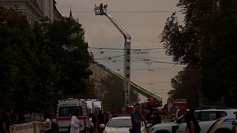 Firefighters work to extinguish a fire after a Russian drone attack struck a building in downtown Kyiv, Ukraine