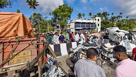 People gather near wreckage of a car after it collided with a lorry parked on the highway at Kaipamangalam, in Thrissur district, Keralam, Saturday, Sept. 5, 2026