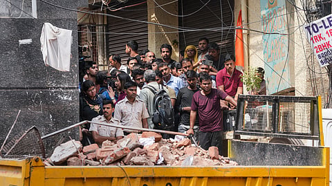 Debris being cleared after the building collapse in Delhi.