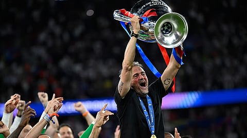 PSG manager Luis Enrique lifts the Champions League for a third time