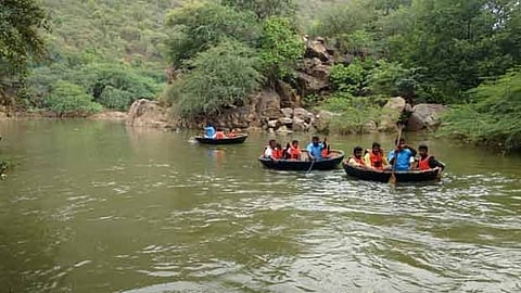 Tourist rides coracle in Hogenakkal