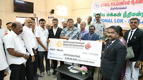 Principal District Judge M Christopher hands over cheque to victim's wife in Tiruchy on September 12.