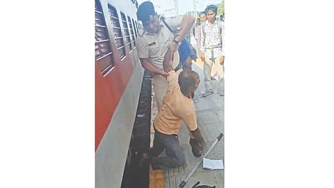 RPF official Amir Singh pulls Hussain up onto platform