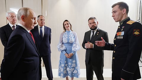 Russian President Vladimir Putin, foreground left, meets with United Russia party leaders, from left, Moscow Mayor Sergei Sobyanin; Putin; Foreign Minister Sergey Lavrov, background second right, Presidential Commissioner for Children's Rights Maria Lvova-Belova, center, war correspondent and Hero of Russia Yevgeny Poddubny, second right; and Chief of the Yunarmiya main headquarters Vladislav Golovin, in Moscow