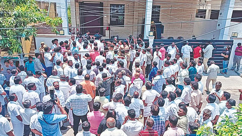 DMK cadres gathered outside Anbil Mahesh’s Tiruchy residence during the search on Wednesday