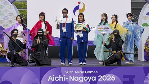 Former Olympian shooter Anjali Bhagwat, right, and former athlete Lijo David during the official welcome and flag-hoisting ceremony for the Indian contingent ahead of the 20th Asian Games, in Nagoya, Japan.