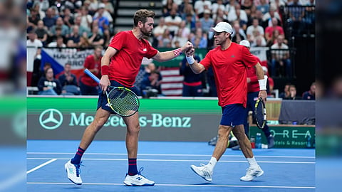United States' Christian Harrison, right, and Austin Krajicek celebrate after winning a point against Czechia's Adam Pavlasek and Patrik Rikl during the Davis Cup second round qualifier match between the Czech Republic and the United States, in Prague.