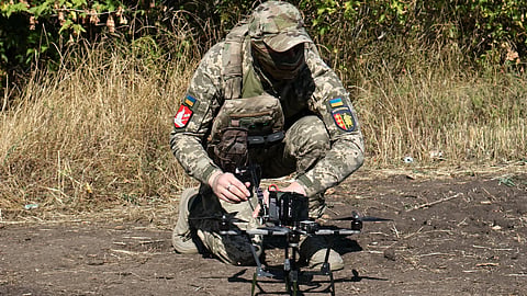 In this photo provided by Ukraine’s 65th Mechanized Brigade press service, a Ukrainian soldier prepares an FPV drone to fire towards Russian positions in Zaporizhzhia region, Ukraine, Saturday, Sept. 19, 2026.
