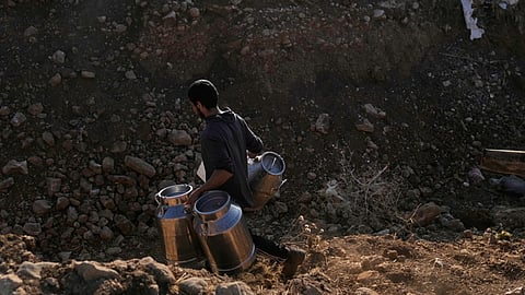 Man carring milk container