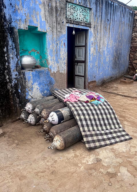 Oxygen cylinders stacked at the house of Manisha, whose husband, Manjit, died from silicosis in Sikar's Syalodra village, Rajasthan.
