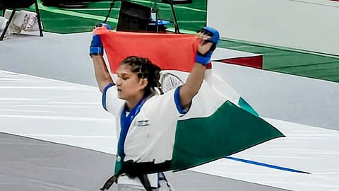 India's Suchika Tariyal takes a victory lap with the tricolour after securing a bronze medal in the women's traditional 60kg mixed martial arts event at the Asian Games in Nagoya, Japan, Monday, Sept. 21, 2026.