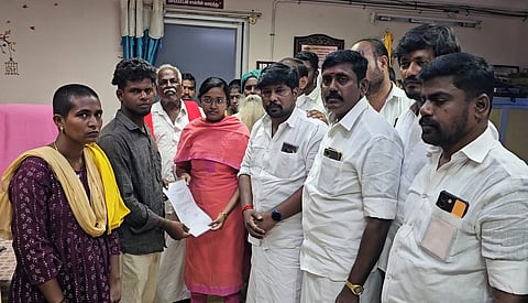 Sivaganga Revenue Divisonal Officer J P Gracia on Sunday is seen handing over the temporary government job appointment order to the two relatives of the youths who were murdered on 16th September.