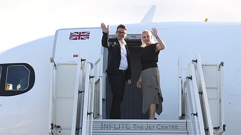 Britain's Prime Minister Andy Burnham and his wife Marie-France van Heel board a plane for the United States, at Stansted Airport, Stansted, England, Monday Sept. 21, 2026, to attend the UN General Assembly in New York.