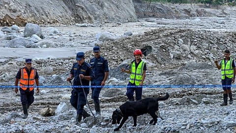 Nepal Police personnel conduct search and rescue operation following the devastating flash flood