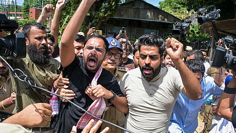 Police personnel detain Cockroach Janta Party (CJP) co-convenor Ashutosh Ranka and other party activists as they raise slogans ahead of their scheduled first regional volunteers' meeting near the Assam Secretariat, in Guwahati, Assam, Sunday, Sept. 27, 2026