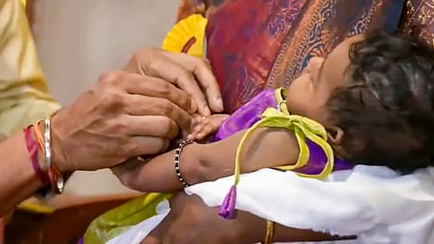 Tamil Nadu Chief Minister C Joseph Vijay presents a gold ring to a newborn baby held by her mother during the launch of the state government's 'Thai Maman Thanga Mothiram' (Maternal Uncle's Gold Ring) scheme, in Madurai, Monday, Sept. 28, 2026
