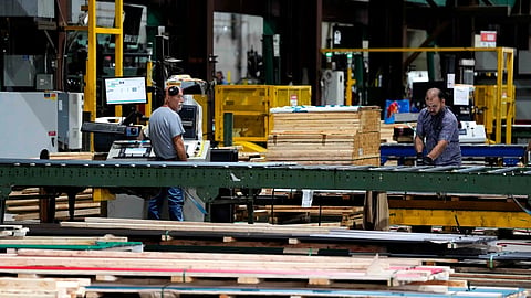 Workers are seen in the manufacturing plant of Ideal Roofing in Ottawa