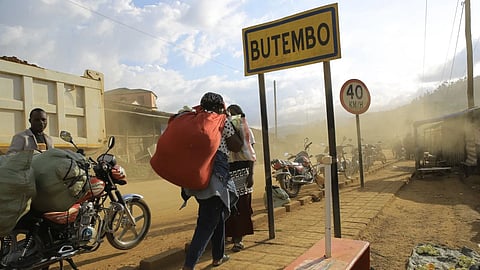 People walk along a street in Butembo, Congo.