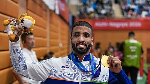 India's Sujeet Kalkal poses for photographs after winning gold medal in the men's Freestyle 65 kilogram final bout 196 wrestling event in the ongoing Asian Games 2026, in Nagoya, Japan, Friday, Oct. 2, 2026
