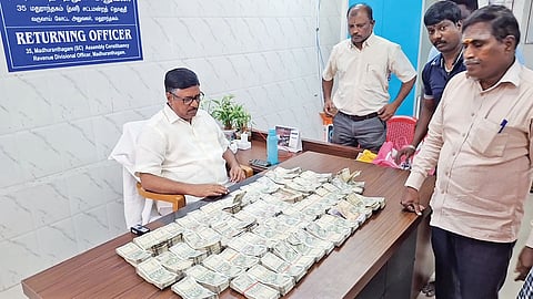 Election officials with the unaccounted cash seized in Madurantakam on October 3.