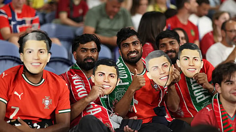 Fans on the stands holding Ronaldo face masks during the Nations League match between Portugal and Norway