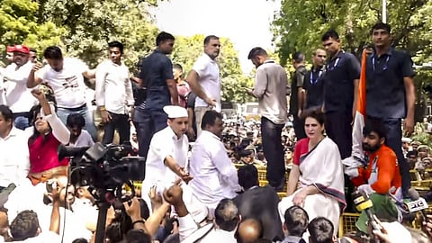 Leader of Opposition in the Lok Sabha Rahul Gandhi, Congress MP Priyanka Gandhi Vadra atop police security barricades after security forces stopped their march from Parliament toward the Election Commission of India (ECI) office, demanding the resignation of Chief Election Commissioner Gyanesh Kumar, in New Delhi.
