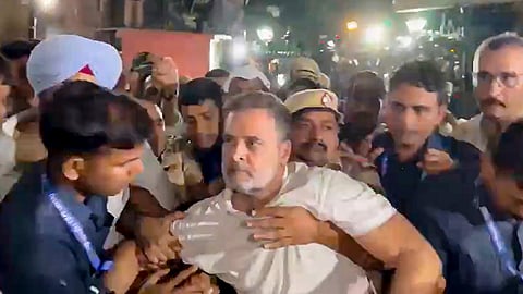 LoP in the Lok Sabha Rahul Gandhi being detained by police personnel after over eight-hour sit-in inside Akashvani Bhawan premises for not being allowed to march towards the Election Commission's office, during a protest march against CEC Gyanesh Kumar