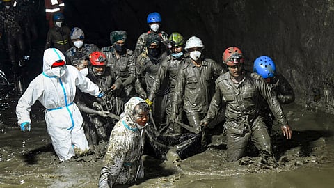 Nepal Army personnel recover a body during an ongoing joint and rescue operation from the tunnel of Chilime Hydropower Project following the devastating flash floods