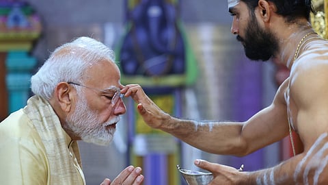 Prime Minister Narendra Modi offers prayers at the Sree Vinayaka Mandir in Sarojini Nagar to mark completing 25 years in public life as head of government, in New Delhi.