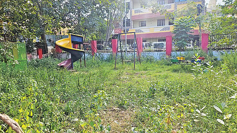 The closed park in Agathiyar Nagar has overgrown vegetationand unused play equipment