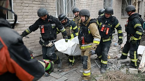 Rescue workers carry a body after pulling from the rubble of a residential building destroyed by a Russian airstrike in Zaporizhzhia, Ukraine.