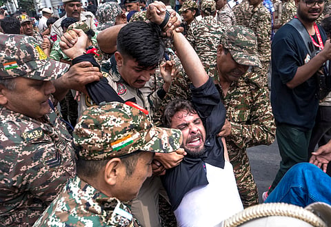 Police personnel detain protestors amid continued demonstration calls by the Cockroach Janta Party (CJP) demanding the resignation of Chief Election Commissioner (CEC) Gyanesh Kumar, in Connaught Place area, New Delhi, Sunday, Oct. 11, 2026