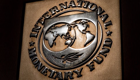 The logo of the International Monetary Fund is visible on its building