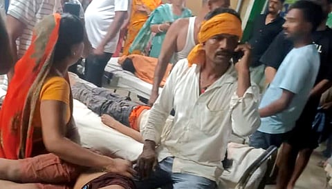 People gather at a local hopital after a boat capsized in the Ganga river, with several people feared drowned, in Bihar's Vaishali district