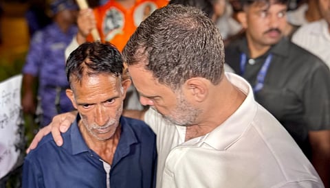Lok Sabha Leader of Opposition (LoP) Rahul Gandhi interacts with father of Ankita Bhandari during a sit-in protest at India Gate
