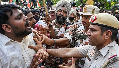 Security personnel detain activists of Indian Youth Congress (IYC) during a protest march toward Parliament Street