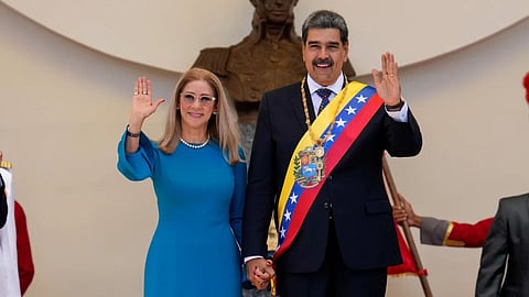 Venezuelan President Nicolas Maduro and his wife Cilia Flores wave after his swearing-in ceremony for a third term at the National Assembly in Caracas, Venezuela.