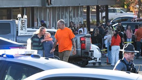 People leave a family meeting area following a shooting at Silver Rail Elementary School in Bend, Ore.