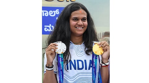 Golfer Pranavi Urs poses with her medals following her win at the 2026 Asian Games, during a felicitation programme, in Mysuru, Karnataka, Wednesday, Oct. 7, 2026