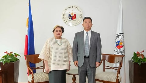 Philippine Foreign Secretary Ma. Theresa Lazaro, left, poses with Chinese Ambassador Jing Quan after he was summoned to the department in Manila, Philippines