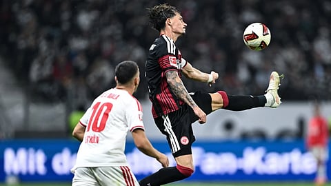 Eintracht Frankfurt’s Robin Koch, right, leaps to control the ball ahead of 1. FC Köln’s Said El Mala during a Bundesliga soccer match, Friday, Oct. 16, 2026, in Frankurt, Germany.