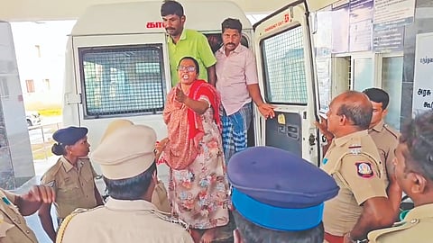 Police personnel escort NTK leader M Karthika for a medical check-up at the government hospital