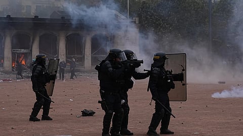 Riot police face protesters during a demonstration against rising living costs and in support of students' grievances in Paris