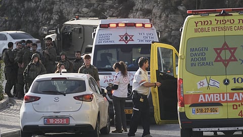 Israeli soldiers and emergency personnel gather near ambulances following a shooting attack near Yehuda Junction, near Hebron, in the occupied West Bank, Friday, Oct. 23, 2026.
