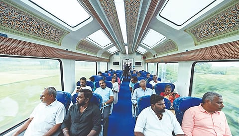 Passengers on the Madurai-Guruvayur Express enjoying the view of the lush landscape on Thursday